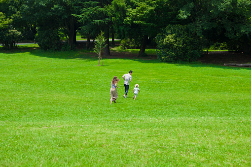 Parents and children running happily in the park