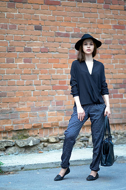 istock The girl standing near a brick wall. 583726566