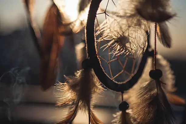 A close-up of a dreamcatcher in the sunlight.