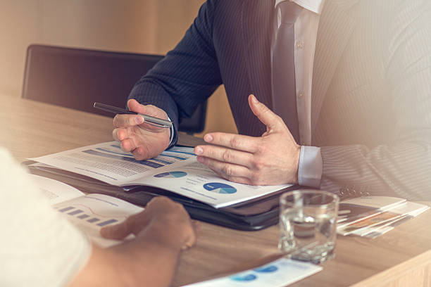 istock Close up of male hands on business document 583728582