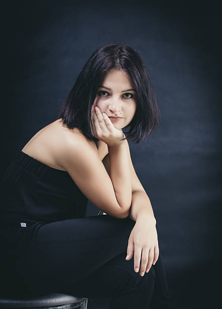 istock young brunette woman sitting 583728888