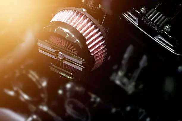 Close up air filter carburettor motorcycle on dark background