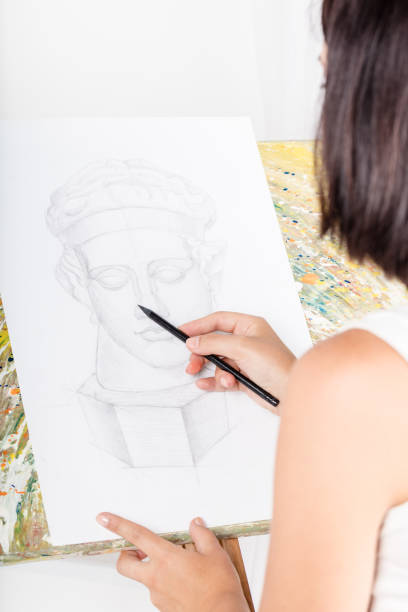 istock young woman paints a picture 583729394