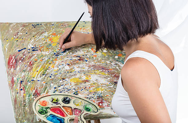 istock young woman paints a picture 583729554