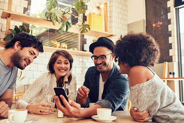 istock Friends in a cafe looking at the photos 583730204
