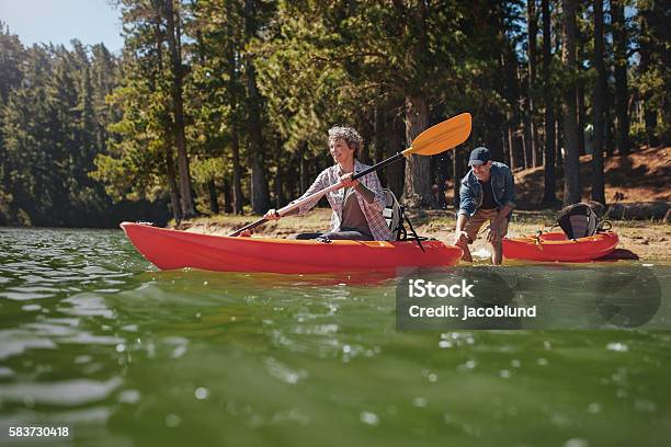 Mature Couple Having Fun Kayaking In The Lake Stock Photo - Download Image Now - Kayak, Kayaking, Mature Adult