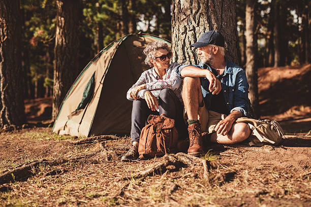 istock Happy senior couple camping in forest 583730720