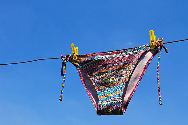 istock Drying woman swimsuit against the blue sky 583731102
