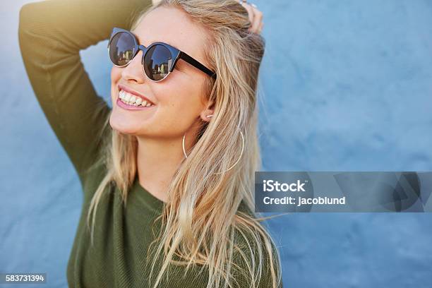 Cheerful Young Woman In Sunglasses Stock Photo - Download Image Now - Sunglasses, Women, One Woman Only