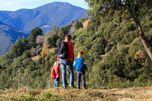 istock father with two kids travel in mountains 583731440