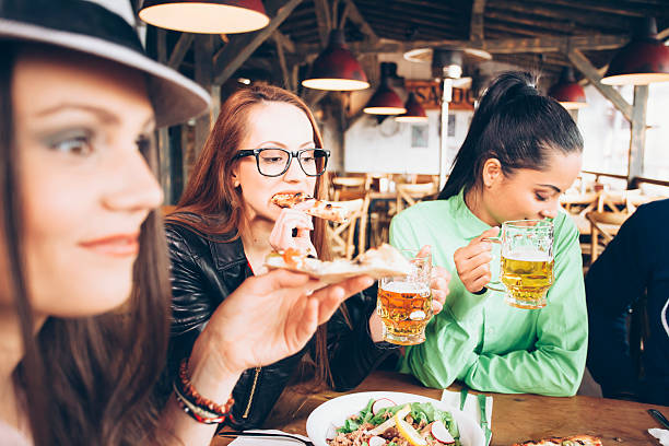 istock Young female friends dining together in a restaurant 583732252
