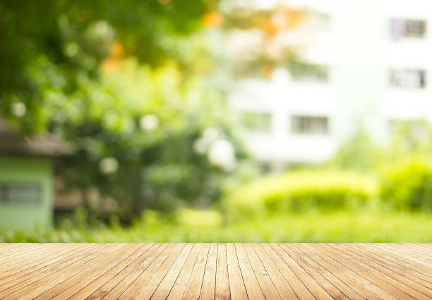istock Empty wooden floor with blurred green garden in hotel 583734048