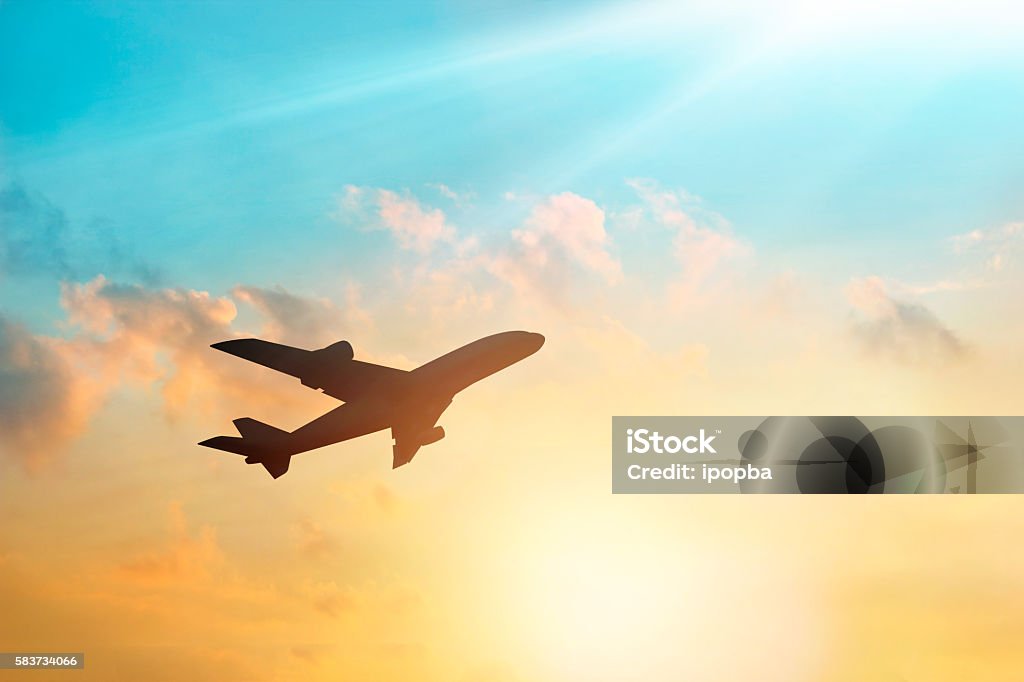 Airplane in the sky and cloud at sunset Airplane Stock Photo