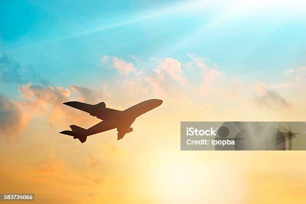 Airplane In The Sky And Cloud At Sunset Stock Photo - Download Image Now - Airplane, Taking Off - Activity, Flying
