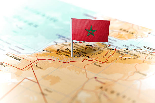The flag of Morocco pinned on the map. Horizontal orientation. Macro photography.