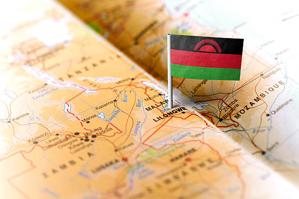 Malawi pinned on the map with flag The flag of Malawi pinned on the map. Horizontal orientation. Macro photography. malawi stock pictures, royalty-free photos & images