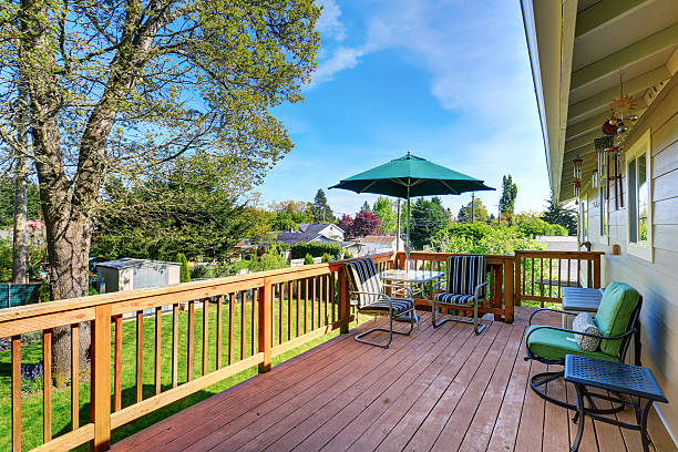 istock Walkout deck with patio table set and umbrella. 583735488