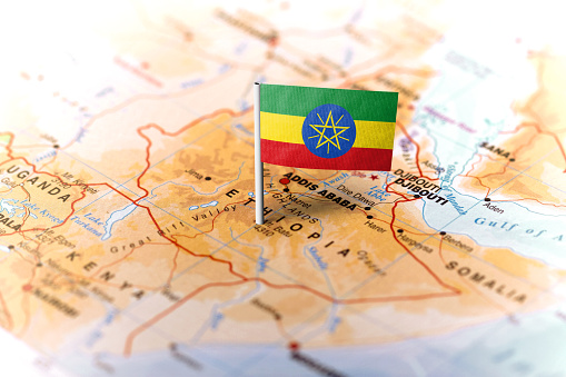 The flag of Ethiopia pinned on the map. Horizontal orientation. Macro photography.