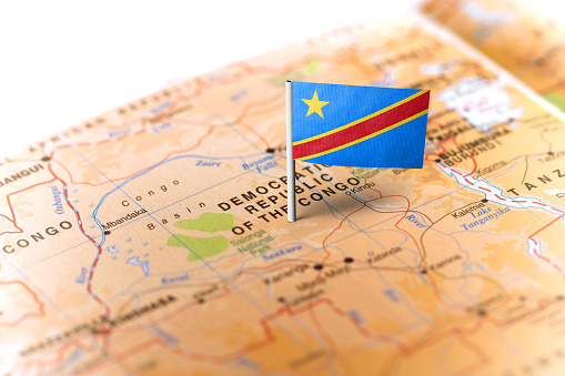 The flag of Democratic Republic of Congo pinned on the map. Horizontal orientation. Macro photography.