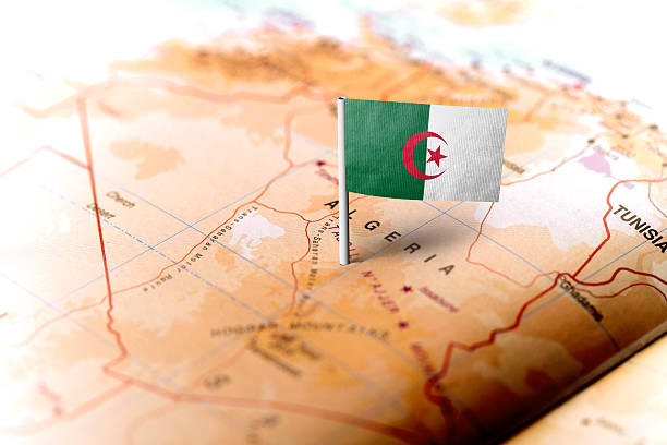 The flag of Algeria pinned on the map. Horizontal orientation. Macro photography.