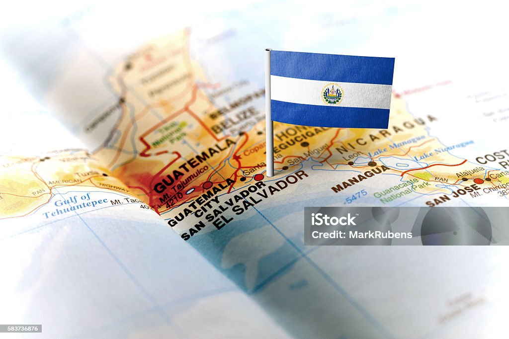 El Salvador pinned on the map with flag The flag of El Salvador pinned on the map. Horizontal orientation. Macro photography. El Salvador Stock Photo