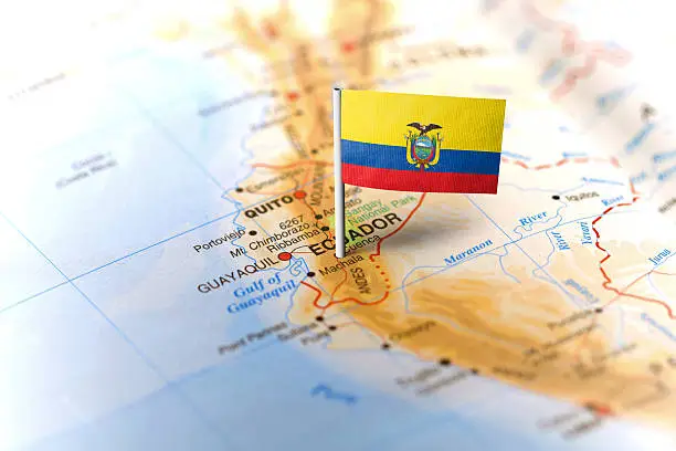 The flag of Ecuador pinned on the map. Horizontal orientation. Macro photography.