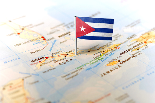 The flag of Cuba pinned on the map. Horizontal orientation. Macro photography.