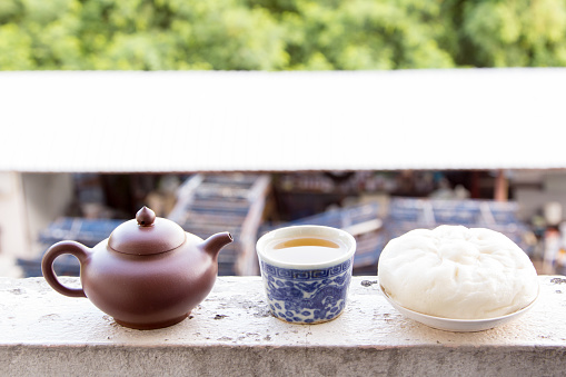 Chinese teapot and Chinese tea and dumplings streamed on the balcony., Chinese cuisine.