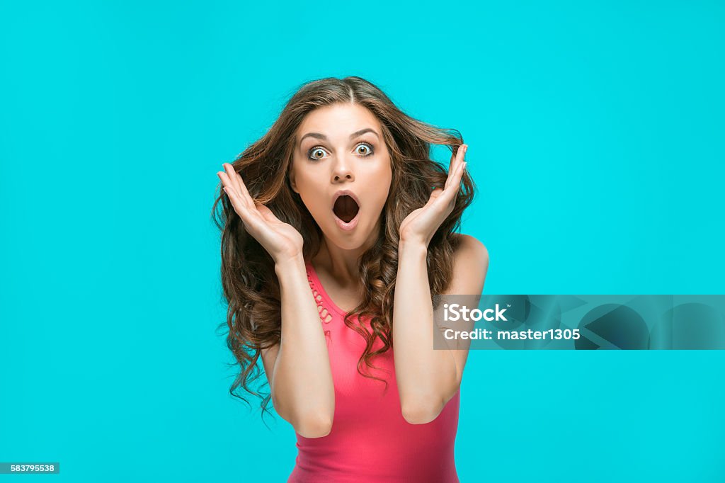 Portrait of young woman with shocked facial expression The portrait of young woman with shocked facial expression Surprise Stock Photo