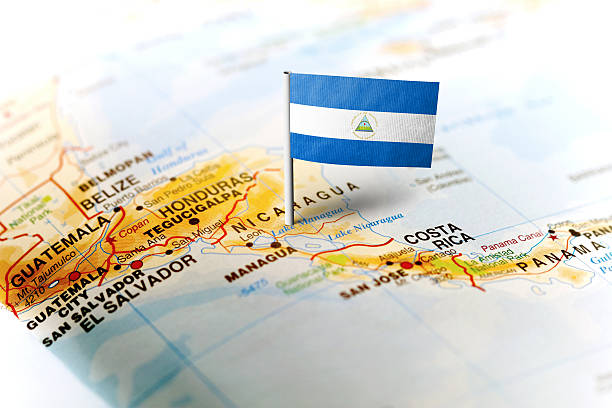 Nicaragua pinned on the map with flag The flag of Nicaragua pinned on the map. Horizontal orientation. Macro photography. nicaragua stock pictures, royalty-free photos & images