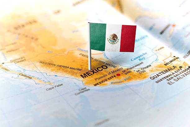 The flag of Mexico pinned on the map. Horizontal orientation. Macro photography.
