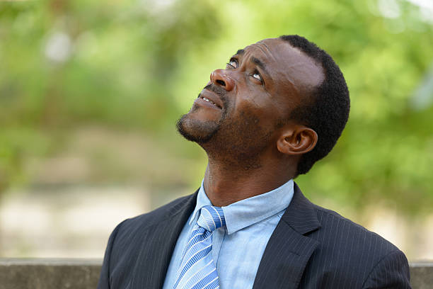 istock African businessman looking up outdoors 583796140