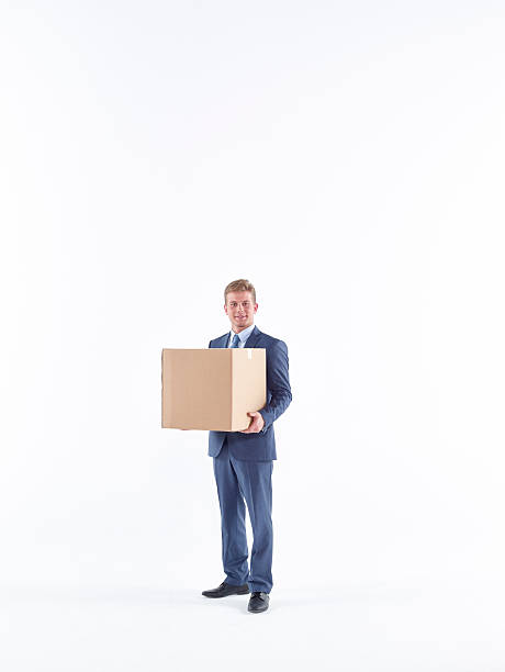 istock Business man carrying cardboard box 583796824