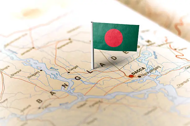 The flag of Bangladesh pinned on the map. Horizontal orientation. Macro photography.