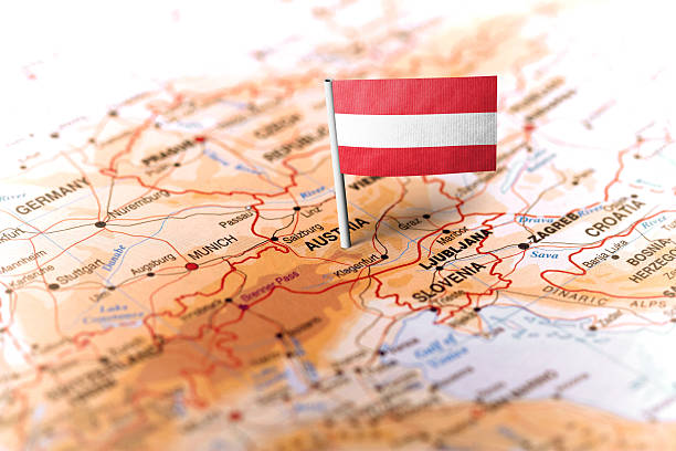 The flag of Austria pinned on the map. Horizontal orientation. Macro photography.