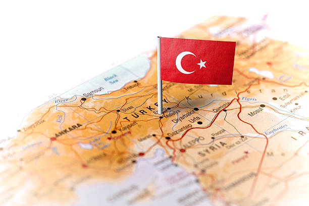 The flag of Turkey pinned on the map. Horizontal orientation. Macro photography.
