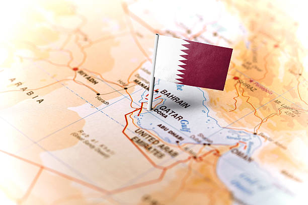 Qatar pinned on the map with flag The flag of Qatar pinned on the map. Horizontal orientation. Macro photography. qatar map stock pictures, royalty-free photos & images