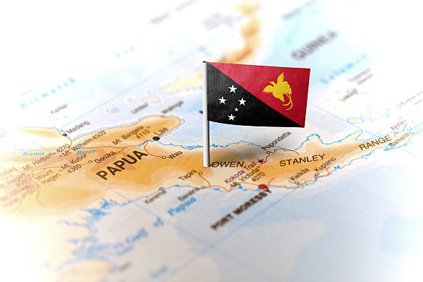 Papua New Guinea pinned on the map with flag The flag of Papua New Guinea pinned on the map. Horizontal orientation. Macro photography. Papua New Guinea stock pictures, royalty-free photos & images