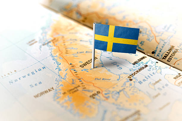 The flag of Sweden pinned on the map. Horizontal orientation. Macro photography.