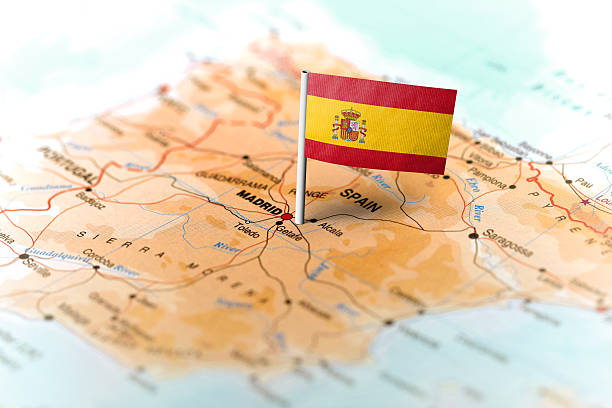 Spain pinned on the map with flag The flag of Spain pinned on the map. Horizontal orientation. Macro photography. spain stock pictures, royalty-free photos & images