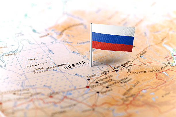 Russia pinned on the map with flag The flag of Russia pinned on the map. Horizontal orientation. Macro photography. russia map stock pictures, royalty-free photos & images