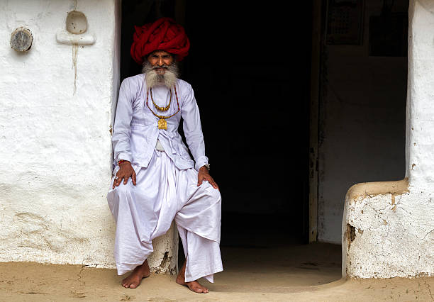 Senior Indian men from the village of Rajasthan resting at the gate of his house.