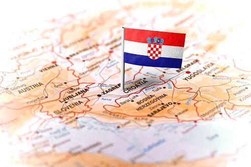 The flag of Croatia pinned on the map. Horizontal orientation. Macro photography.