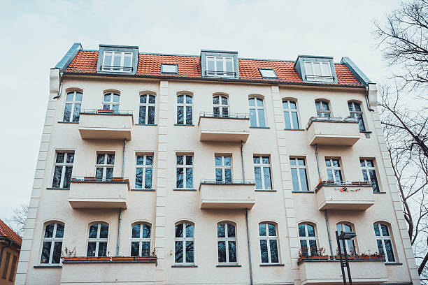 istock White colored exterior of apartment building 583800928