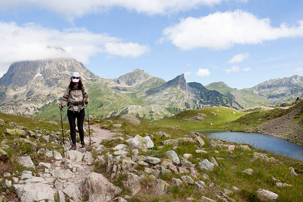 istock hiker woman between stones and a lake 583802274