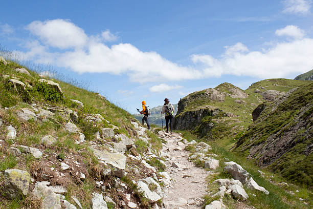 istock two mountaineers hiking between the mountains 583802316