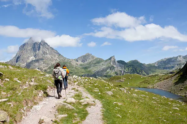 two hiker in front of the Midi d'Ossau and in the Ayous Lakes, Pyrenees, France