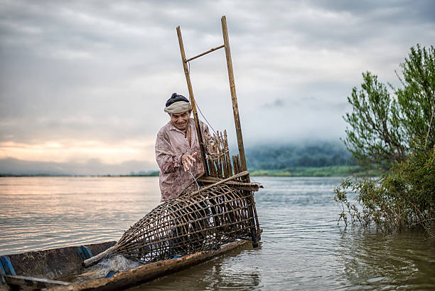 istock Fisherman on boat in action when fishing 583803530