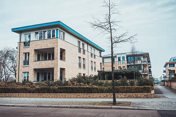 istock Modern apartments with blue rimmed roof 583804374