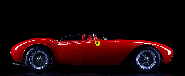 London, England - July 27, 2016: The side view of a scale model of the 1954 Ferrari 375 Plus against a black background. 